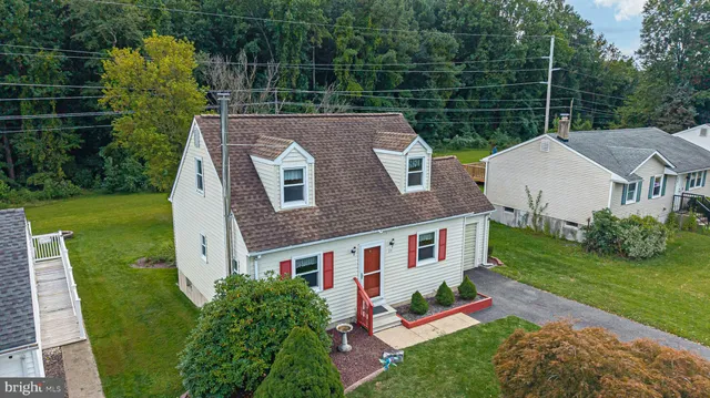 an aerial view of a house with a garden and swimming pool
