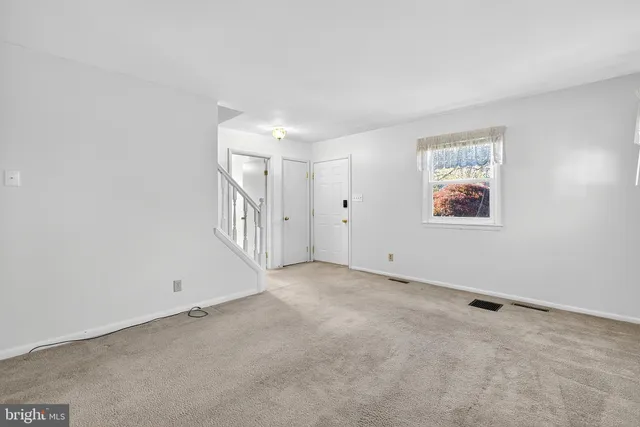 a kitchen with granite countertop a sink a window stainless steel appliances and cabinets