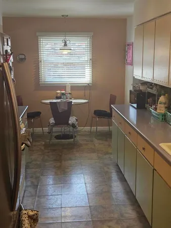 a view of a kitchen with dining area and windows