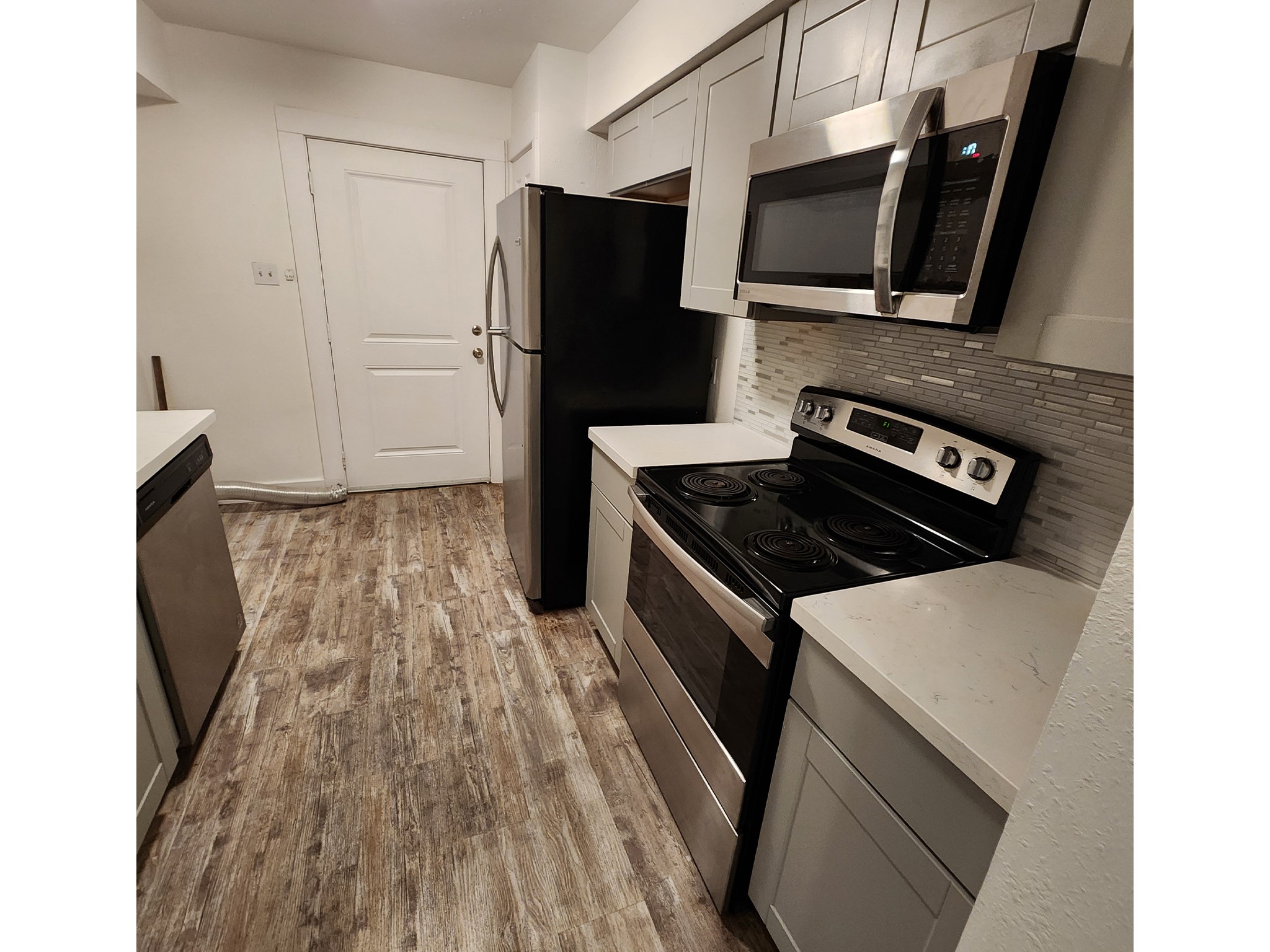 a kitchen with wooden cabinets and black appliances