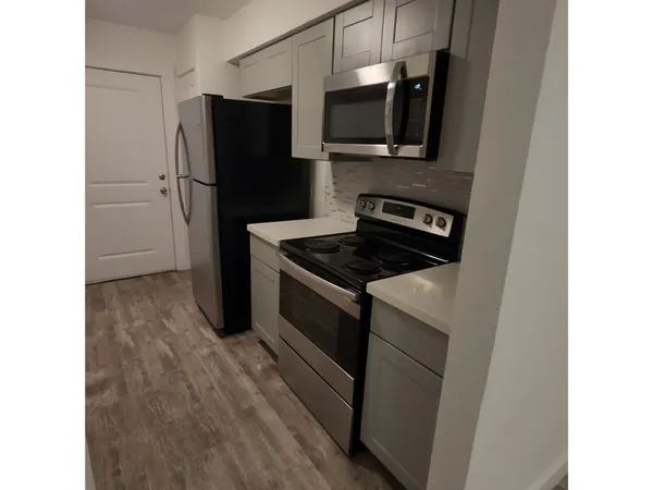 a kitchen with a refrigerator stove and microwave