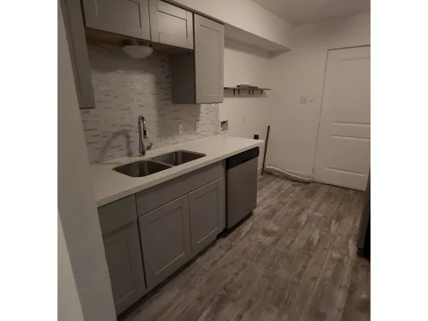 a kitchen with a sink and cabinets