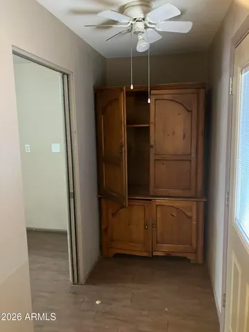 a view of a yard in front of a house with plants and large tree