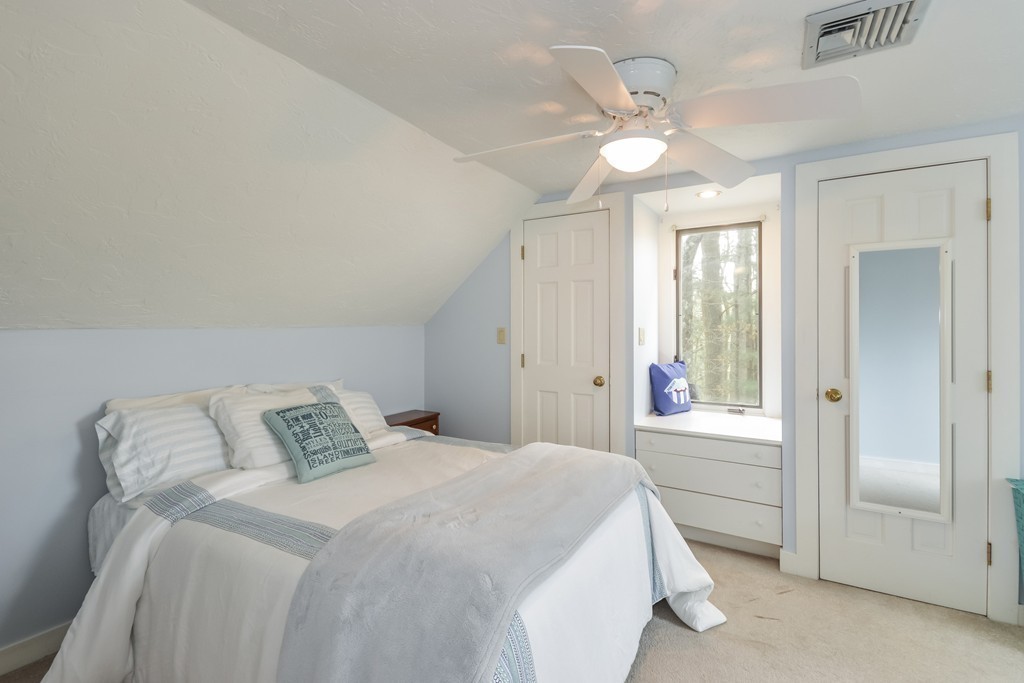 14 Forge Way Duxbury, MA 02332 - Photo 15 of 26 a bedroom with a large bed and a chandelier