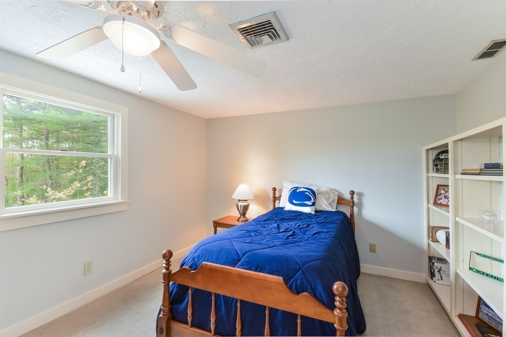 14 Forge Way Duxbury, MA 02332 - Photo 16 of 26 a bedroom with a bed and a chandelier