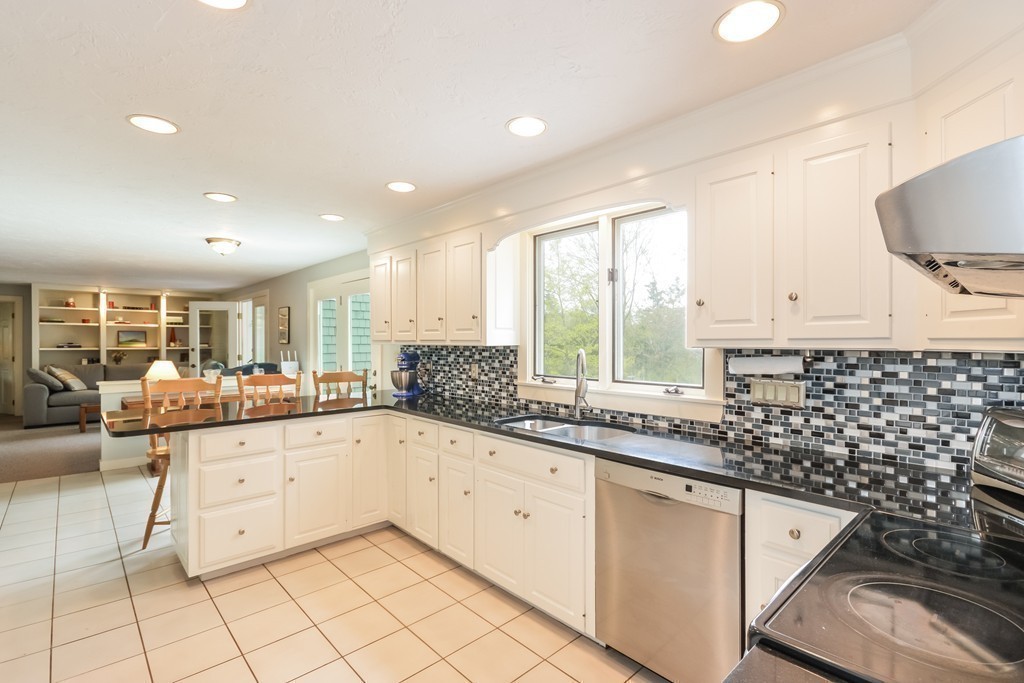 14 Forge Way Duxbury, MA 02332 - Photo 4 of 26 a kitchen with granite countertop a sink and white cabinets