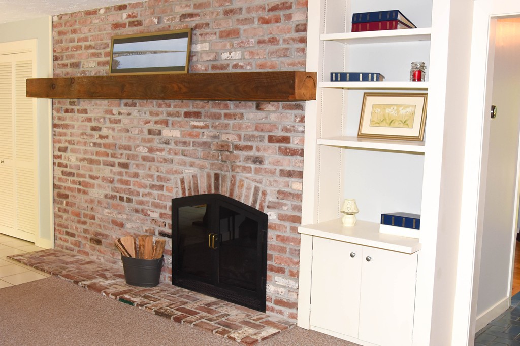 14 Forge Way Duxbury, MA 02332 - Photo 5 of 26 a room with a fireplace and cabinets