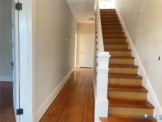 a view of entryway and gallery with wooden floor