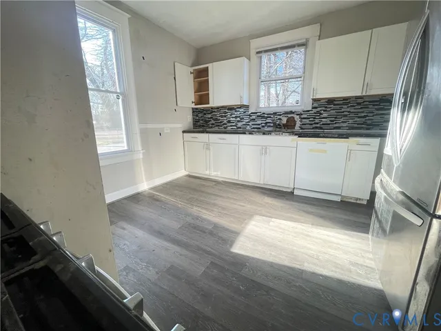 a kitchen with granite countertop a stove and cabinets