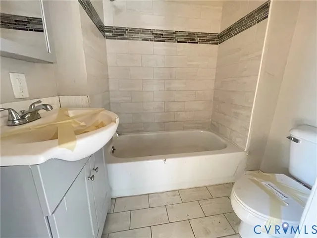 a bathroom with a sink a toilet and bathtub