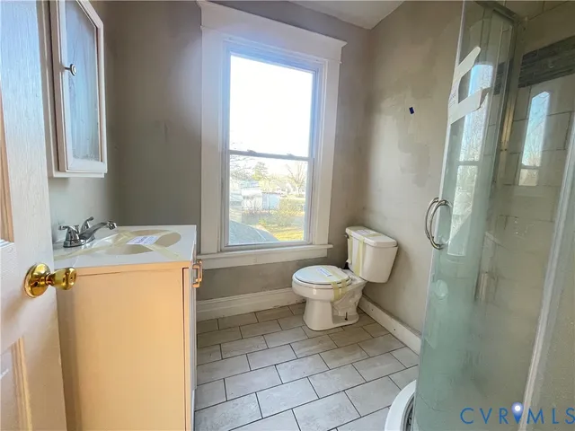 a white toilet sitting next to a bathroom sink
