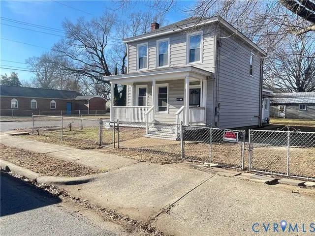 a view of a house with snow on the road
