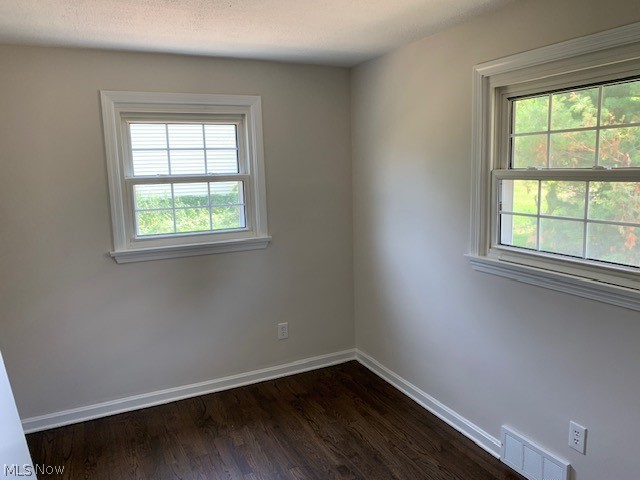 38522 Rogers Road Willoughby, OH 44094 - Photo 8 of 9 Unfurnished room featuring a healthy amount of sunlight and dark wood-type flooring