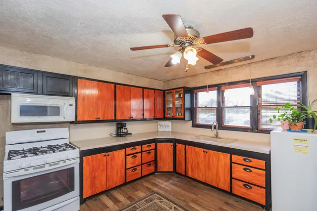 a kitchen with stainless steel appliances granite countertop a sink stove and cabinets