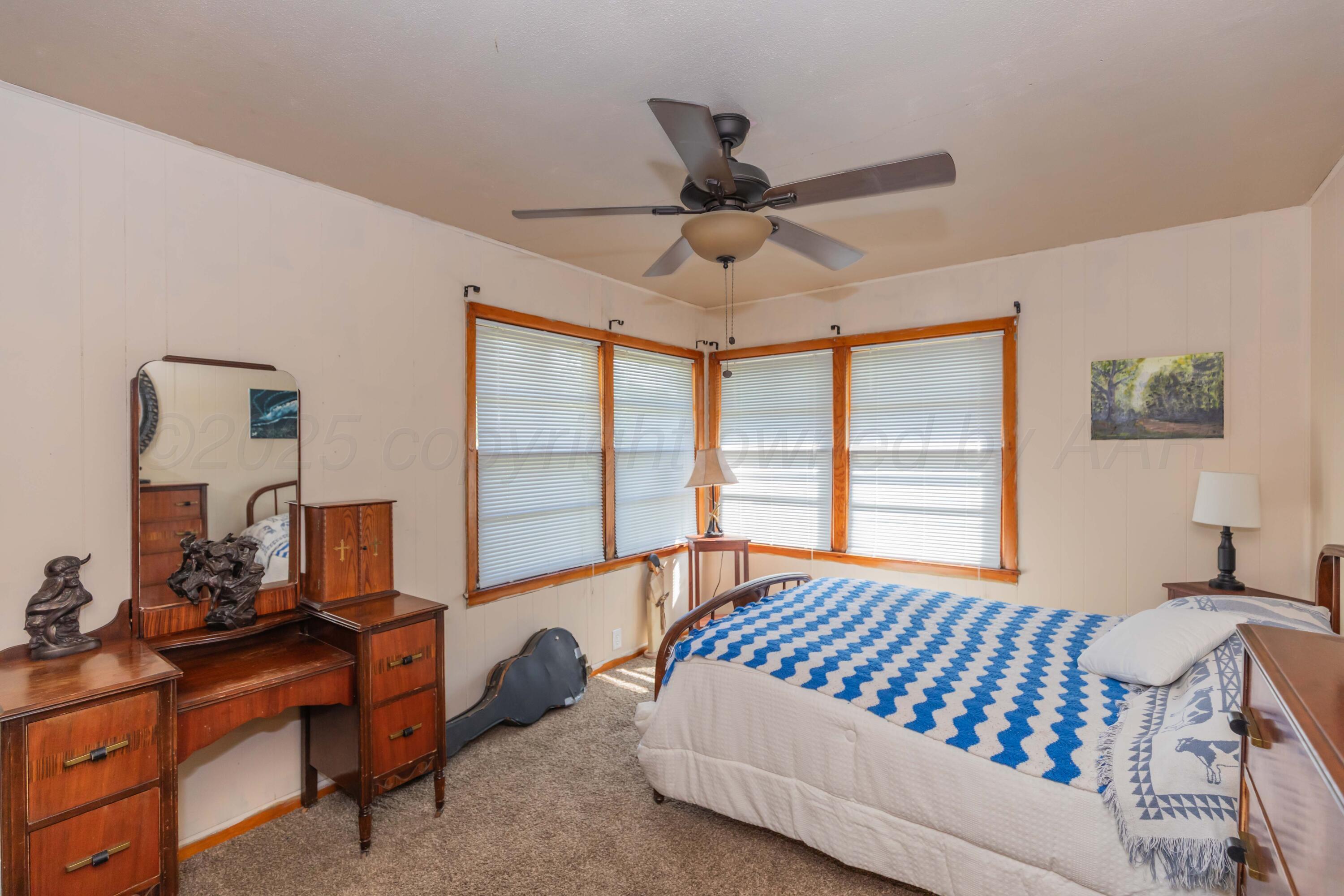 209 East 12th Street Wheeler, TX 79096 - Photo 21 of 40 a bedroom with a bed and a window