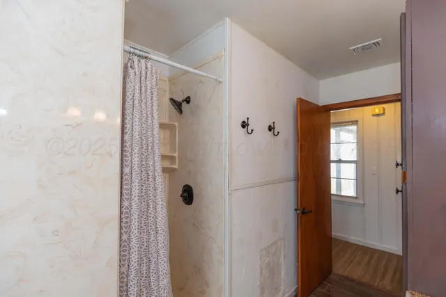 a bathroom with a shower and a sink