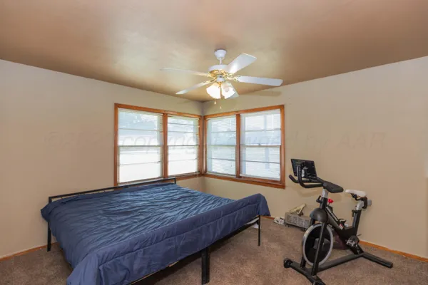 a bed sitting in a room next to a window