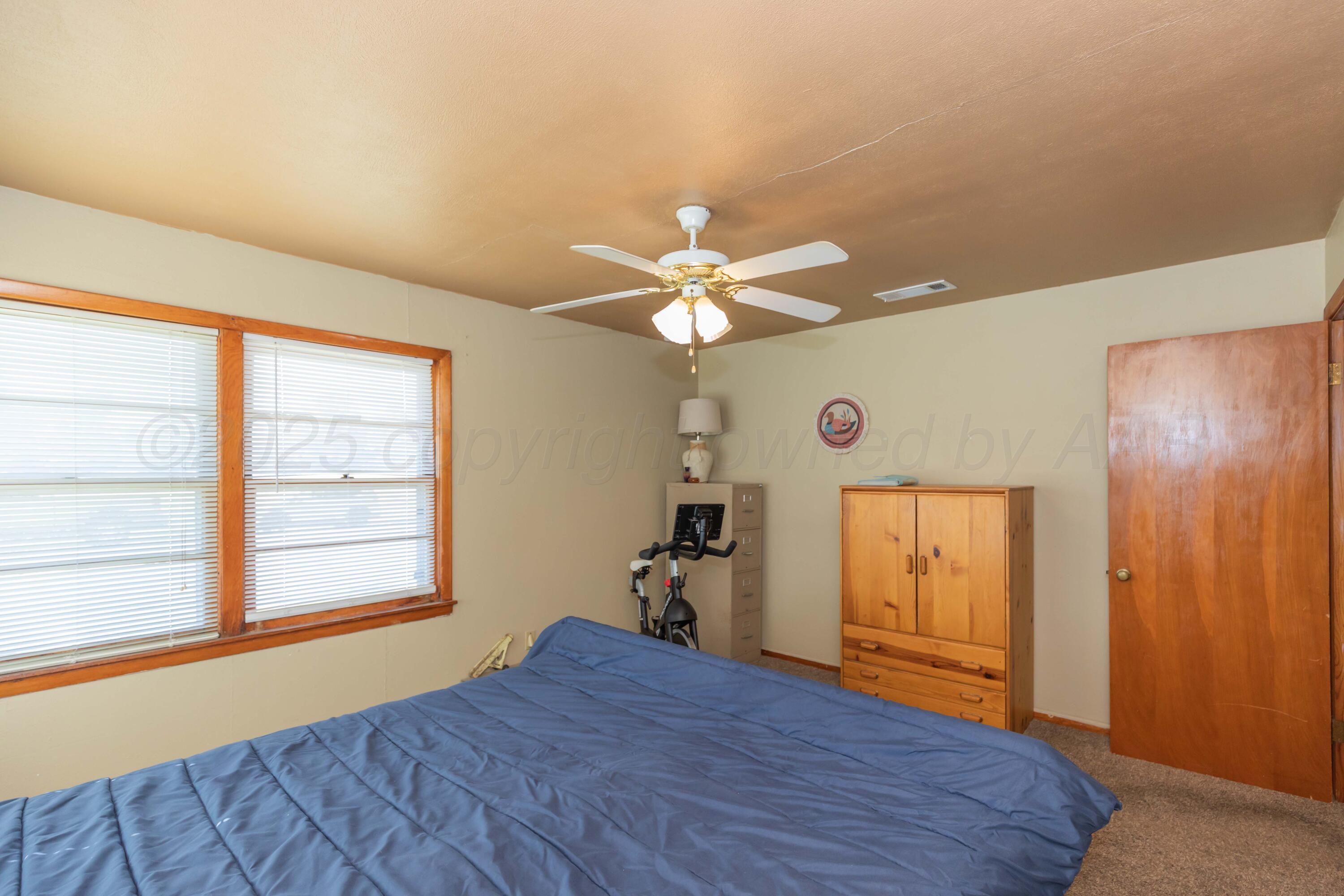 209 East 12th Street Wheeler, TX 79096 - Photo 29 of 40 a view of a livingroom with a chandelier fan and a window