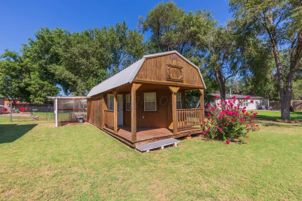 a view of a tiny house with yard