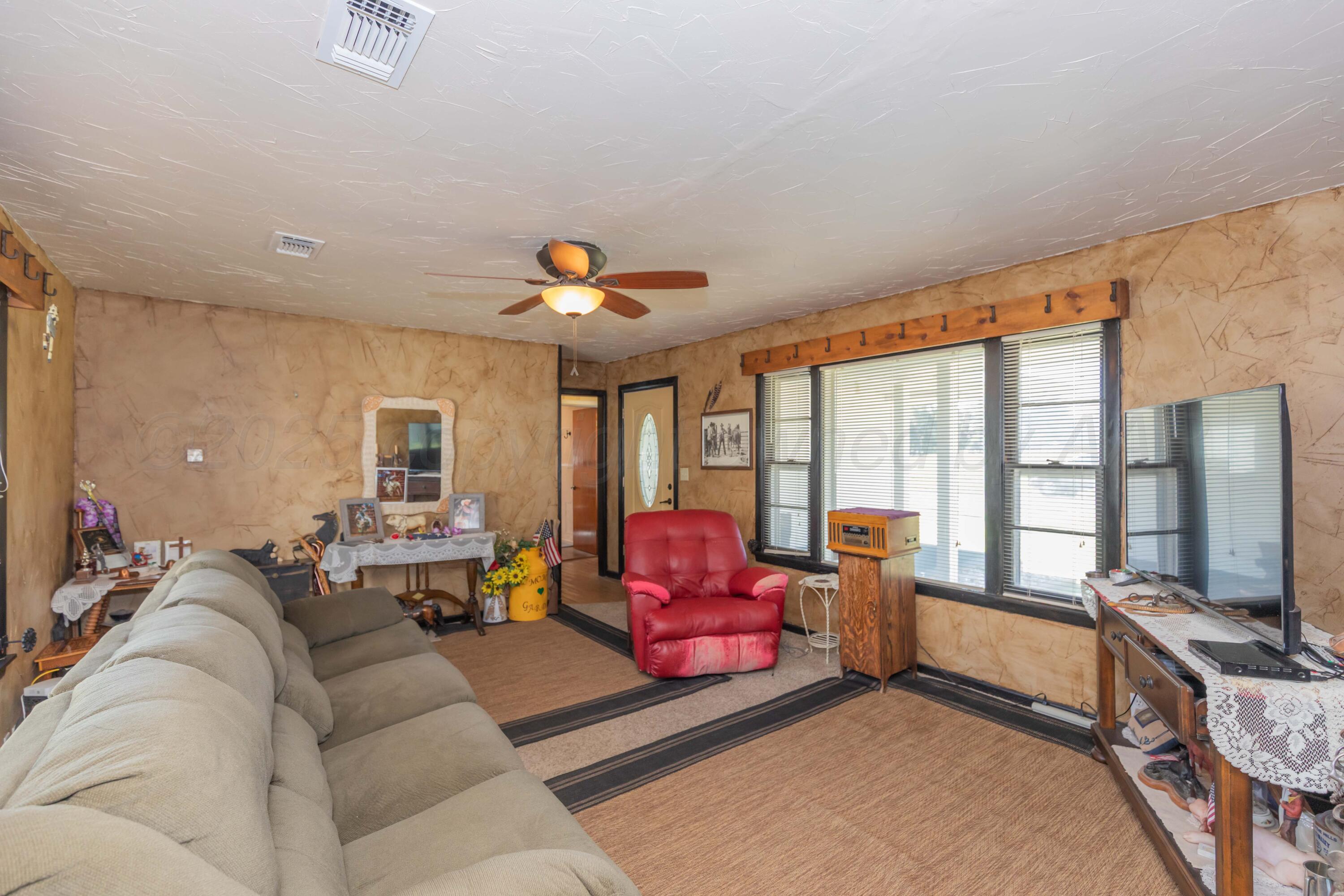 209 East 12th Street Wheeler, TX 79096 - Photo 4 of 40 a living room with furniture and a flat screen tv