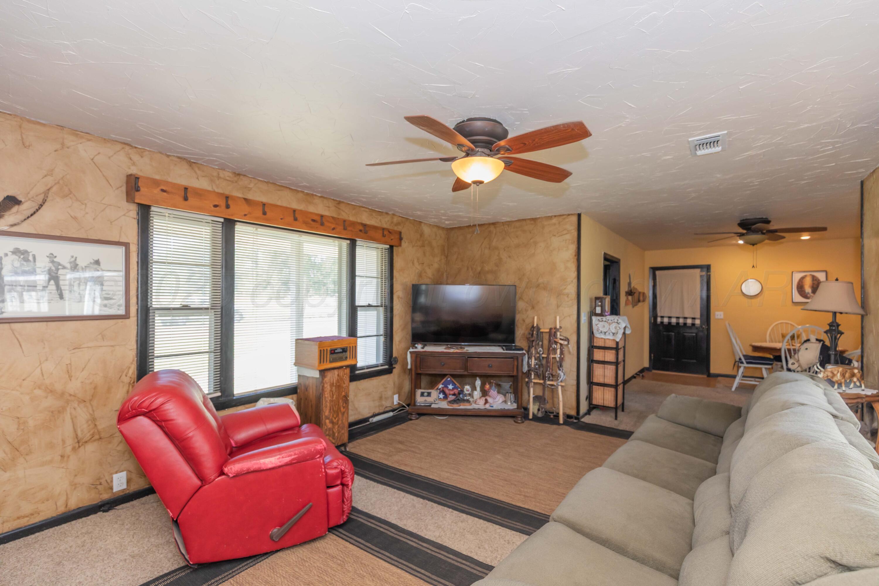 209 East 12th Street Wheeler, TX 79096 - Photo 6 of 40 a living room with furniture and a flat screen tv
