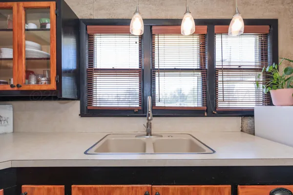 a view of kitchen with furniture and windows