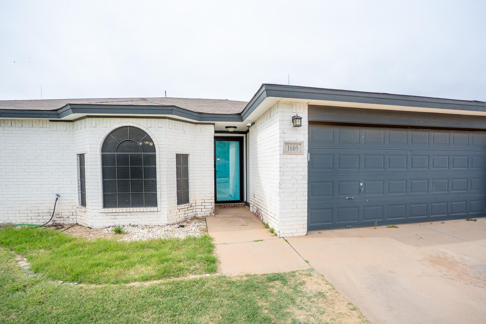 1609 78th Street Lubbock, TX 79423 - Photo 3 of 36 a front view of a house with garage