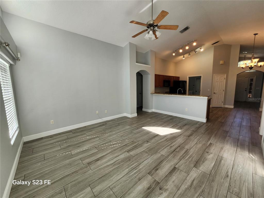 12518 Sparkleberry Road Tampa, FL 33626 - Photo 12 of 24 wooden floor in an empty room with a window