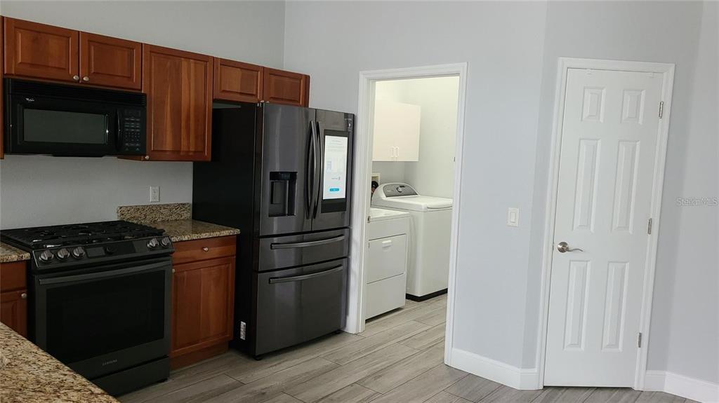 12518 Sparkleberry Road Tampa, FL 33626 - Photo 13 of 24 a kitchen with a stove and a microwave