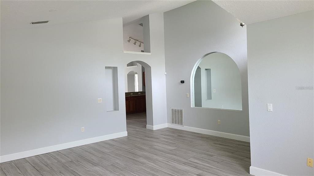12518 Sparkleberry Road Tampa, FL 33626 - Photo 15 of 24 an empty room with wooden floor and mirror