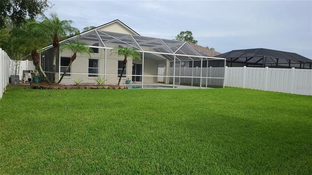 12518 Sparkleberry Road Tampa, FL 33626 - Photo 23 of 24 a view of a house with a yard and sitting area
