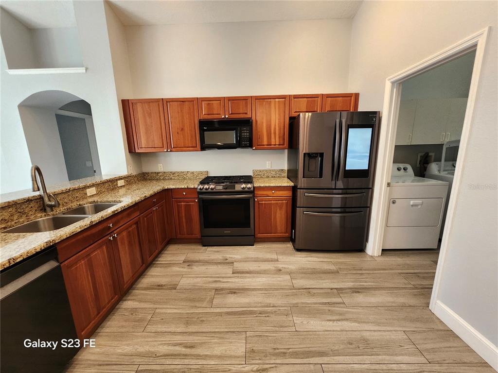 12518 Sparkleberry Road Tampa, FL 33626 - Photo 4 of 24 a kitchen with stainless steel appliances granite countertop a stove top oven a sink and dishwasher