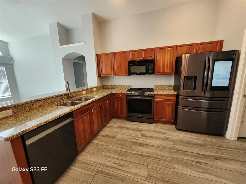 12518 Sparkleberry Road Tampa, FL 33626 - Photo 5 of 24 a kitchen with stainless steel appliances granite countertop a stove a sink and a refrigerator