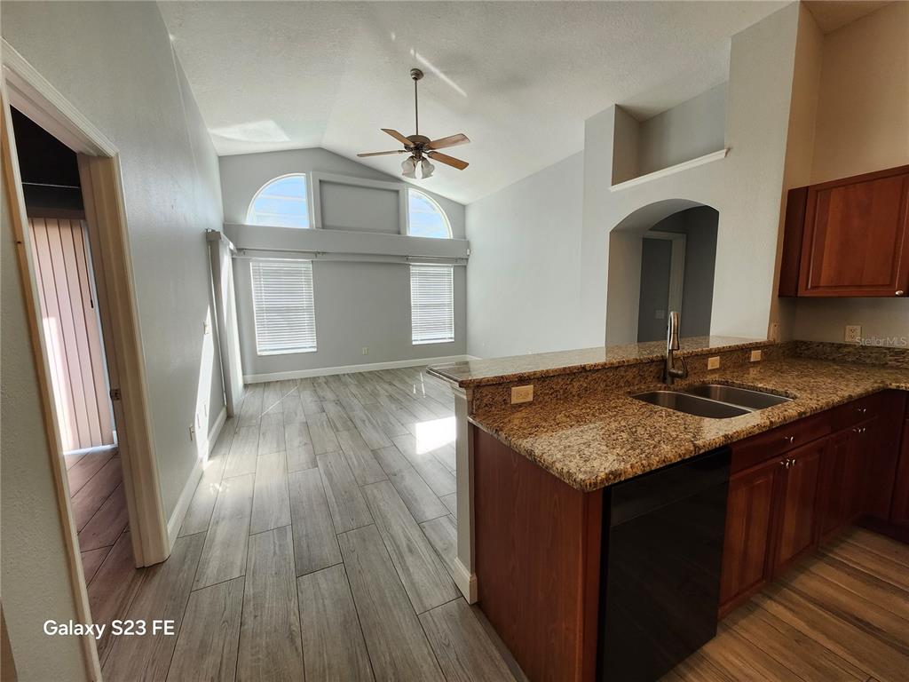 12518 Sparkleberry Road Tampa, FL 33626 - Photo 6 of 24 a kitchen with sink cabinets and wooden floor