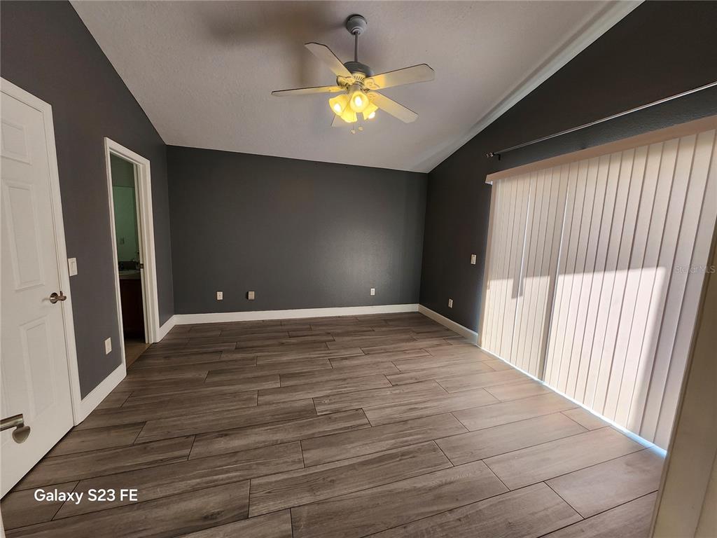12518 Sparkleberry Road Tampa, FL 33626 - Photo 7 of 24 a view of an empty room and window and wooden floor