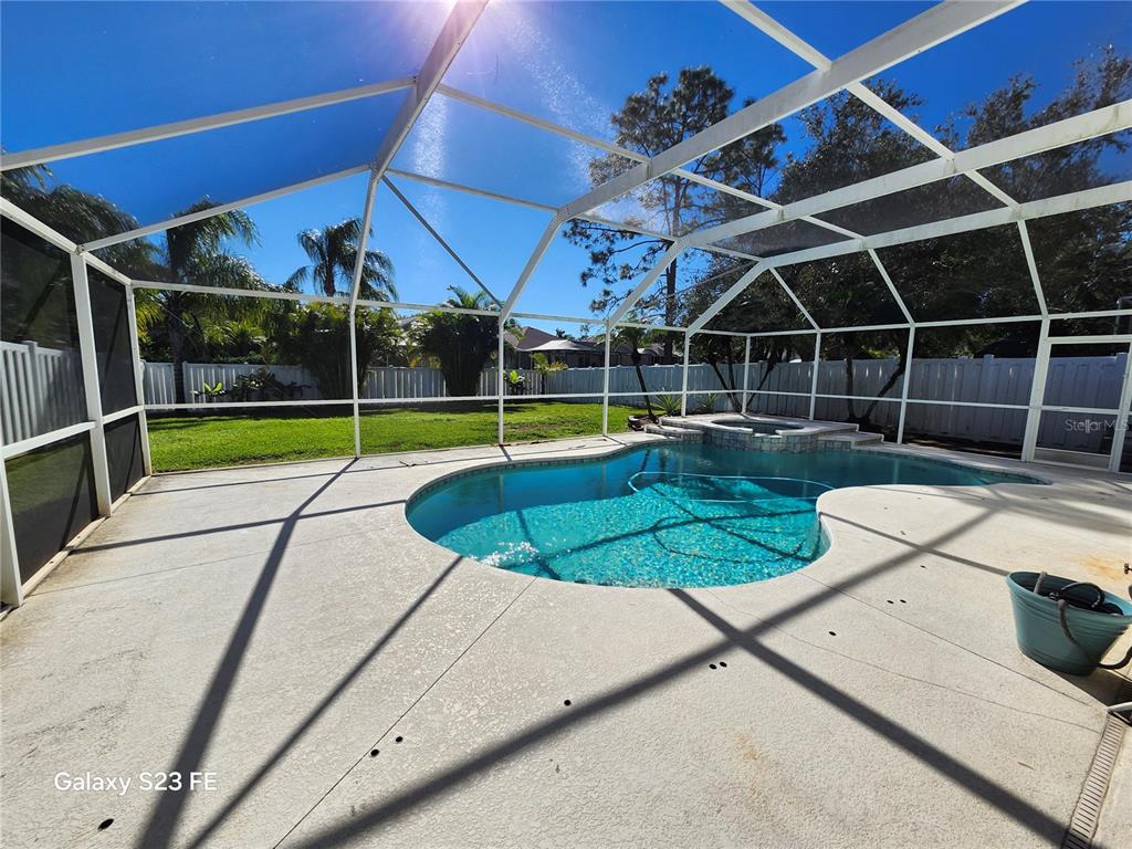 12518 Sparkleberry Road Tampa, FL 33626 - Photo 9 of 24 a view of a backyard with swimming pool and sitting area