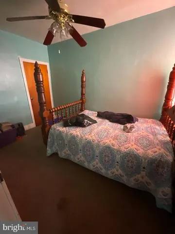 a bedroom with a bed and dresser