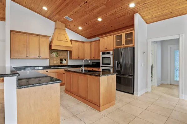 a dining room with furniture and a floor to ceiling window