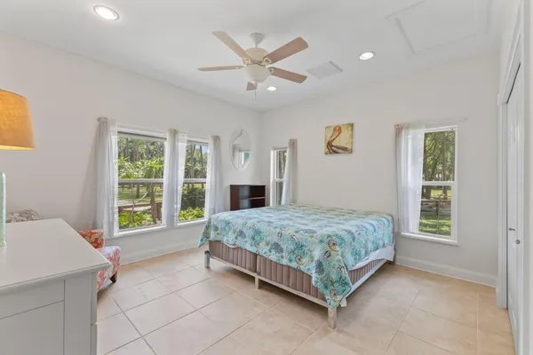 a living room with stainless steel appliances furniture a rug and a window