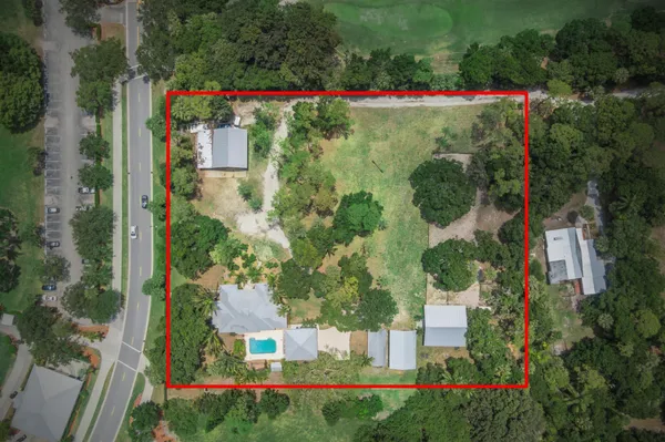 an aerial view of a house with a yard and garden