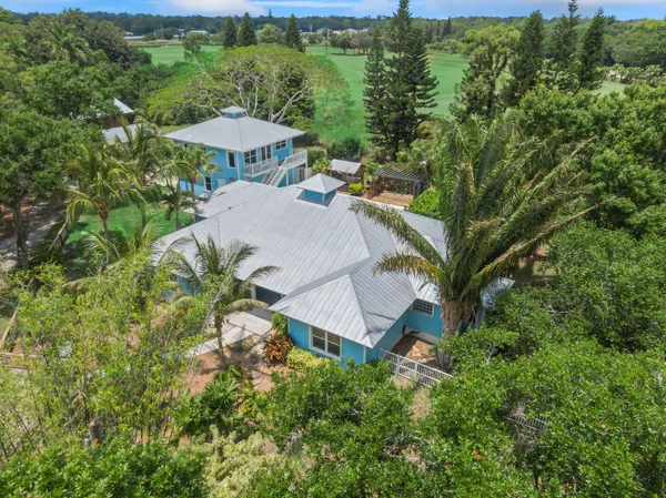 an aerial view of a house with a yard basket ball court and outdoor seating
