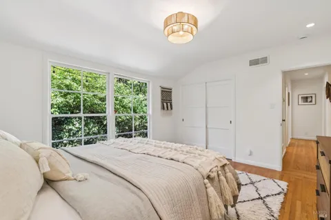 a bedroom with bed and a window