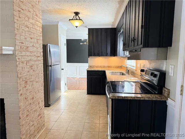 a kitchen with a stove and a refrigerator