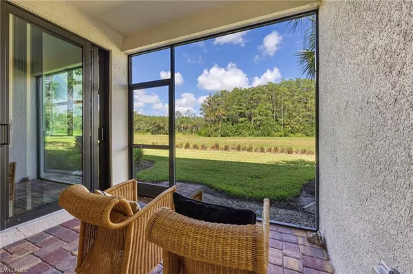 a view of a porch with furniture and garden