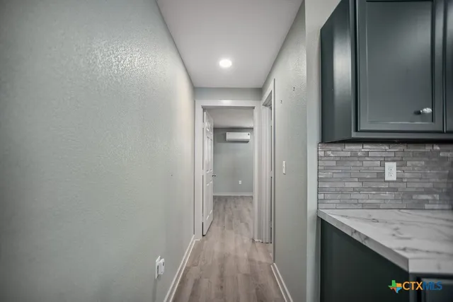 a bathroom with a granite countertop sink a toilet and shower