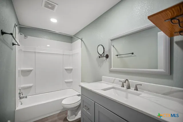 a bathroom with a toilet and a bath tub