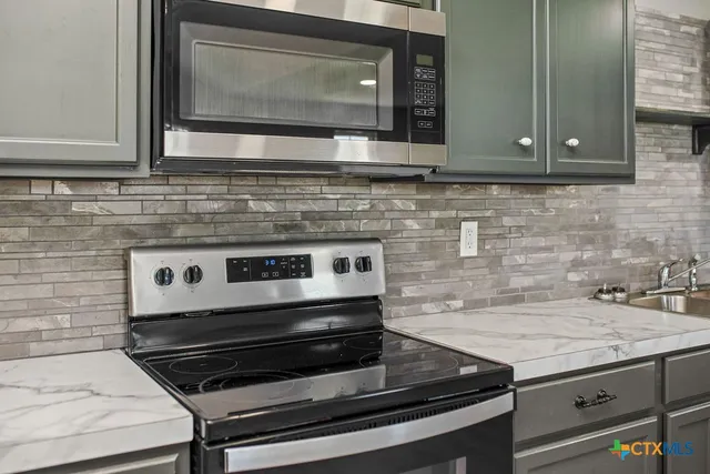 a kitchen sink with granite countertop a sink