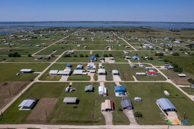an aerial view of a house with a lake view