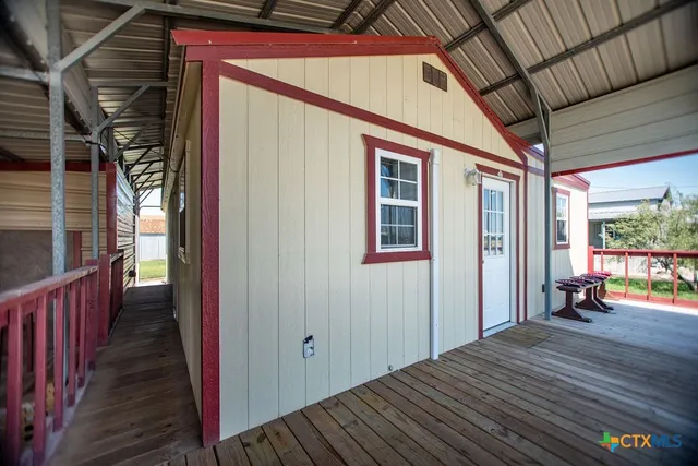 a view of a porch with wooden floor and outdoor space