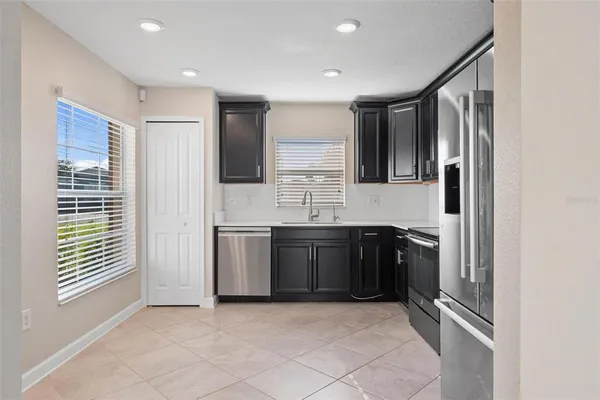 a view of an empty room with a kitchen